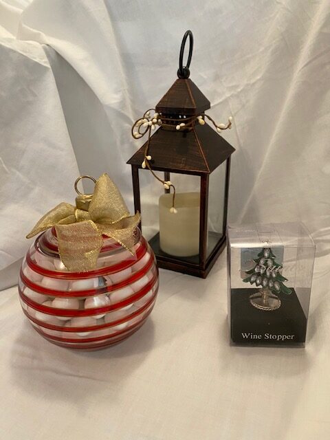 Striped bowl of candy, candle lantern, wine stopper