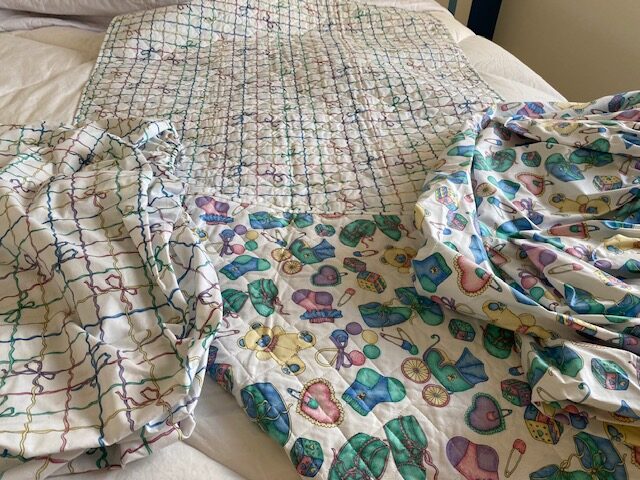 Double-sided quilt and matching crib sheets