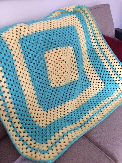 blue and yellow crocheted square afghan