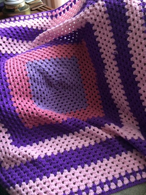 pink and purple crocheted square afghan